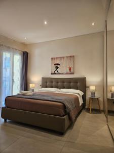 a bedroom with a bed and a painting on the wall at La Rosa del lago in Stresa