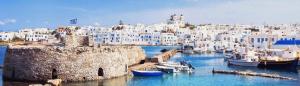 a group of boats in a harbor with buildings at Koukounari Cottage Apartment Paros in Naousa
