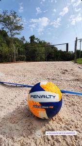 an orange and blue ball sitting on the sand at Pousada Recanto do Amanhecer in Socorro