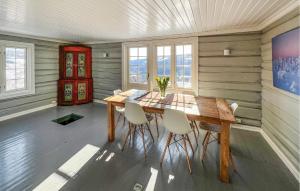 a dining room with a wooden table and chairs at Stunning Home In Svatsum With House A Panoramic View in Svingvoll