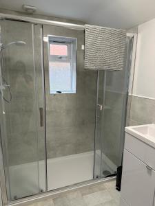 a shower with a glass door in a bathroom at 3 Bed Chill Glouc in Gloucester