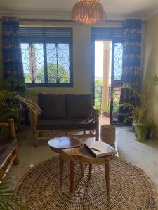 a living room with a couch and a coffee table at Kitiko residence Hotel in Entebbe