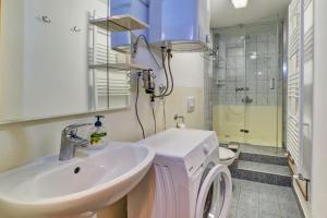 a bathroom with a sink and a shower and a toilet at House ROSSELLA with cozy apartment and rooms close to the beach in Nerezine