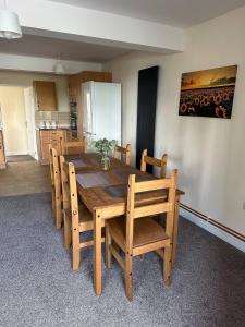 a dining room with a wooden table and chairs at Yellow Sunflowers Flat In Stroud in Stroud