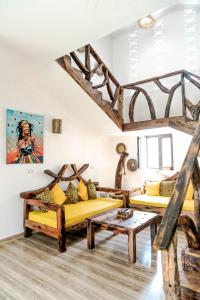 a living room with two couches and a table at Z-Lodge Zanzibar in Kiwengwa