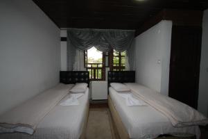 מיטה או מיטות בחדר ב-Efe Guest House
