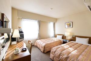 Voodi või voodid majutusasutuse Hotel Keifuku Fukui Ekimae toas