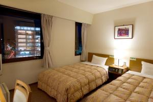 Voodi või voodid majutusasutuse Hotel Keifuku Fukui Ekimae toas