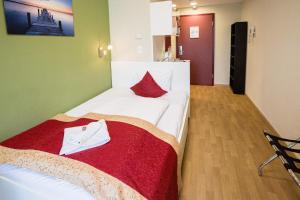 1 dormitorio con cama blanca y manta roja en Di Verdi Imperial Hotel en Budapest