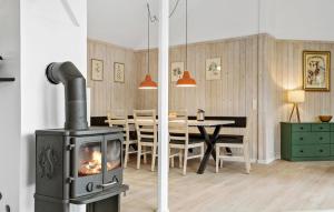a living room with a fireplace and a dining room at Pet Friendly Home In Knebel With Wifi in Knebel