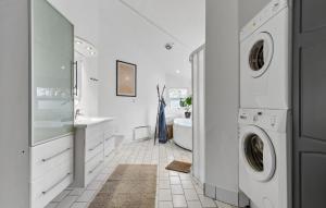 a white bathroom with a washer and dryer in it at Pet Friendly Home In Knebel With Wifi in Knebel