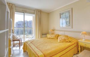 a bedroom with a bed and a large window at Cozy Apartment In Mandelieu-La-Napoule in Mandelieu-la-Napoule