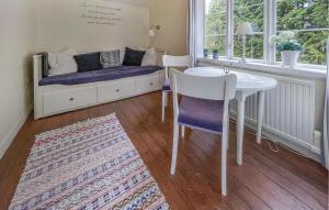 a room with a table and a bed and a table and chairs at 3 Bedroom Gorgeous Home In Frilless in Frillesås
