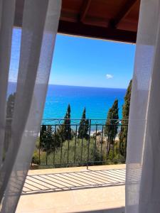 a view of the ocean from a balcony at Stefanos Apartments by SV Alians in Agios Gordios