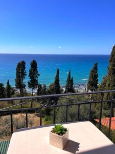 a table on a balcony with a view of the ocean at Stefanos Apartments by SV Alians in Agios Gordios