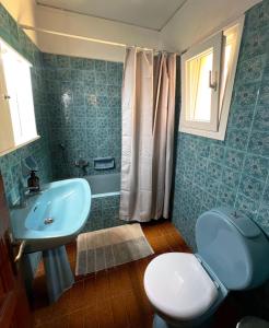 a bathroom with a sink and a toilet and a sink at Stefanos Apartments by SV Alians in Agios Gordios