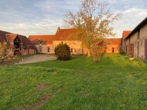 a large yard with a group of buildings at Domaine Le Sciau in Couzon