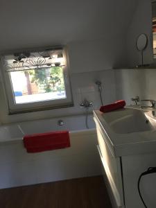 baño con lavabo y ventana en Häuschen direkt am See mit Sauna, en Bestensee