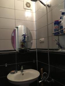 a bathroom with a sink and a mirror at Qax İlisu in Qax