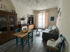 a living room with a table and a couch at LES BAIGNEUSES in Dieppe