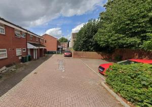 a brick street with two cars parked on it at Sublime Stays Coventry- Jenner Pet Friendly Apartment with Parking in Coventry