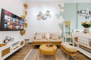a living room with a couch and a tv at Pearland -D'Eldorado Apartment in Hanoi