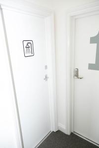 a corridor with two doors with a sign on them at Camden Town Self Check-in Luxury Rooms in London
