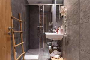 a bathroom with a sink and a shower at Aparthotel Herzblick GmbH in See +90 photos