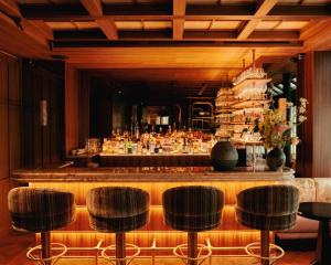 a bar with a counter and some chairs at Hotel Hana in Paris