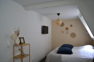 a bedroom with a bed with blue pillows on it at Het Wapen van Noordwijkerhout in Noordwijkerhout