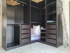 a walk in closet with black walls and shelves at Le temps d'une pause in Villes-sur-Auzon