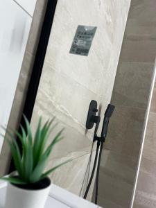 a glass shower door with a phone on it at Aggelis Urban Life in Ioannina