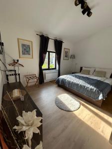 a bedroom with a bed and a large window at Slovenian House Vida in Bled