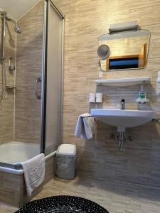 a bathroom with a sink and a toilet and a shower at Chalet MOOS in Todtmoos