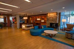 a lobby with a blue couch and a table at Fairfield Inn & Suites by Marriott Geneva Finger Lakes in Geneva