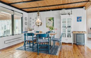 a dining room with blue chairs and a table at 3 Bedroom Gorgeous Home In Kalundborg in Kalundborg
