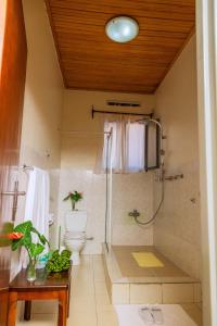 a bathroom with a shower and a toilet at One Click Hotel in Kigali