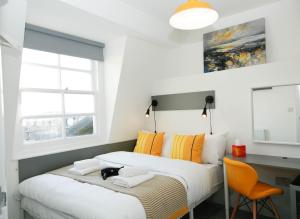 a bedroom with a large bed with a desk and a desk at Camden Town Self Check-in Luxury Rooms in London