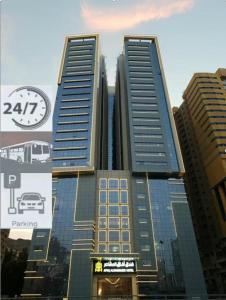 a tall building with a sign in front of it at فندق أفاق المشاعر in Mecca