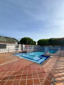 a swimming pool with a fence around it at Casa frente al centro comercial Guatapuri in Valledupar
