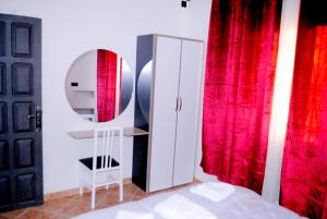 a bedroom with a mirror and a white cabinet at Airport apartment 1 