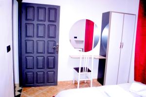 a bathroom with a black door and a mirror at Airport apartment 1 