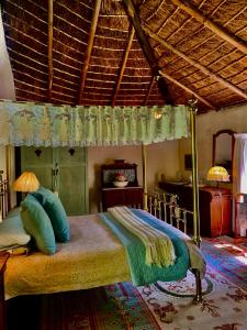 a bedroom with a bed with a canopy at Back o' the Moon Holiday cottage in Hogsback