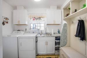 - une cuisine blanche avec des placards blancs et un évier dans l'établissement Modern Oasis Near Washington DC, à Silver Spring