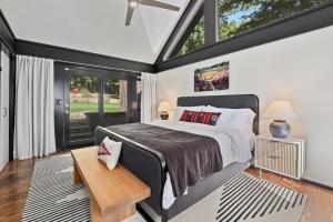 a bedroom with a large bed and a window at Retro Razorback-Pickleball-Golf-Spa-UofA in Fayetteville