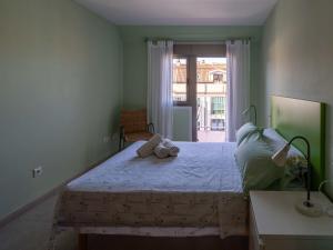 a bedroom with a bed with a teddy bear on it at Apartment Edificio Bahia II by Interhome in Miño