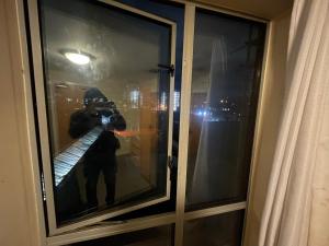 a person taking a picture of a window with a camera at Immaculate 2-Bed Duplex Apartment in Leeds in Leeds