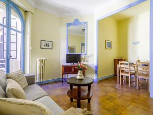 a living room with a couch and a table at Apartment Les Colisées by Interhome in Nice