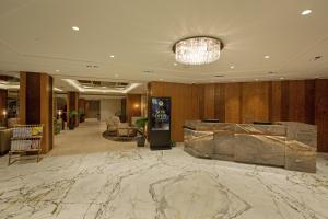 a lobby with a marble floor and a chandelier at ARISTA BY AMBITION in Guwahati