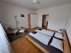 グラーツにあるFlataid Apartment Elisabethinergasseのベッドルーム1室(ベッド1台、椅子1脚付)